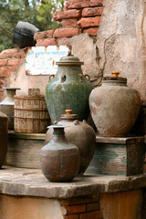 Old desert water well and vessels of water; Desert water stop for thirsty travelers
