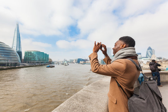 Man taking a picture in London with his smart phone