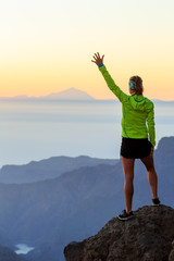 Woman hiking success in mountains sunset - 98089393