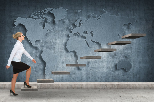 Business woman walking up a staircase. world map on background
