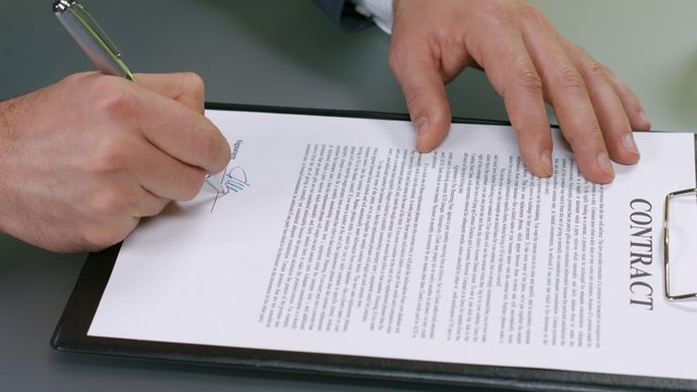 Businessman signs a contract.  