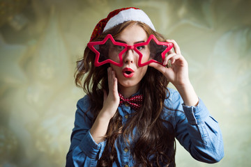 Exciting funny hipster beautiful young lady in santa hat