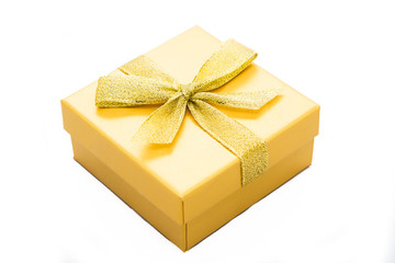 Yellow gift box with ribbon isolated on white background