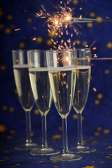 Glasses with champagne against holiday lights