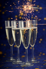 Glasses with champagne against holiday lights