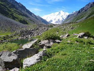 Fototapeta na wymiar mountain valley with snow capped mount Karakol at the end