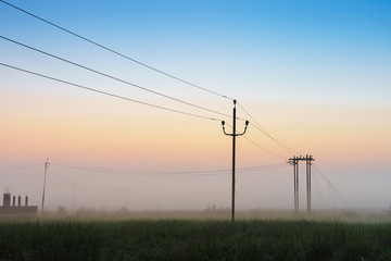 Fototapeta na wymiar Silhouette pillar and electricity line in countryside