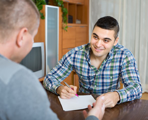 Agent and client with documents at home
