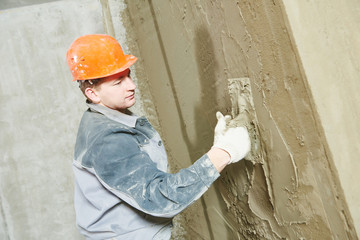 Plasterer at work with wall