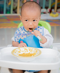 eating baby with spoon