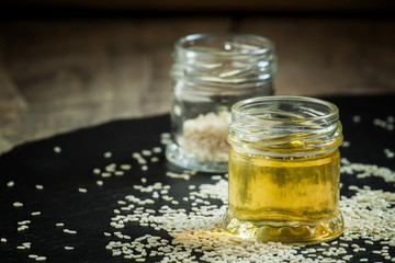 Sesame oil in the pot and sprinkled sesame seeds, selective focu