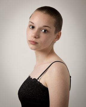 Shaven Bald Teenage Girl With Black Top and Bare Shoulders
