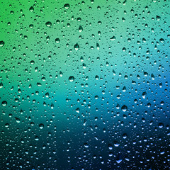Raindrops on a window pane. Droplets of water on the glass. Water drops background.