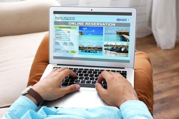 Man using laptop to book hotel online