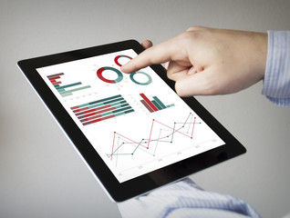 financial graphs on a tablet