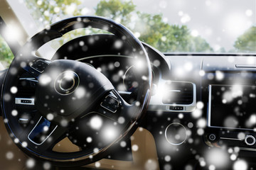 Modern car interior. Steering wheel over snow effect