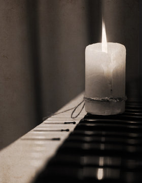 Monochrome image, spent candle, piano