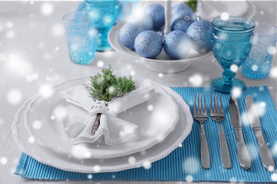 Beautiful Christmas table setting over snow effect