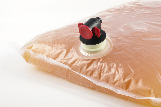 Pouch with tap of pasteurised apple juice isolated for Bag-in-box solution