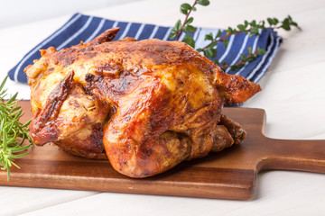 Baked chicken on white plate.