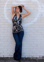 Short Haired Woman Against Brick Wall Outdoors