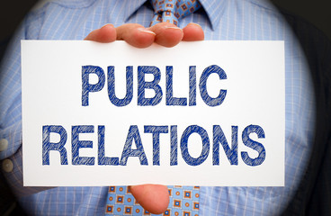 Public Relations - Manager holding white card with blue text