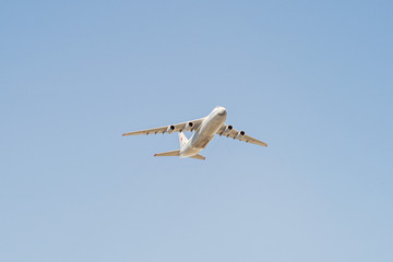 An-124-100 Ruslan (Condor) the world largest cargo strategic airlift jet airplane flies on blue sky background