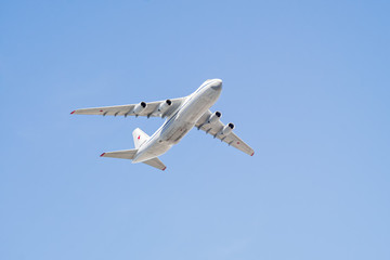 An-124-100 Ruslan (Condor) the world largest cargo strategic airlift jet airplane flies on blue sky background