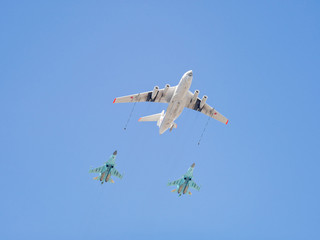 Ilyushin Il-78 (Midas) four-engined aerial refueling tanker demonstrates refueling of 2 Sukhoi Su-34 (Fullback) twin-seat fighter-bombers