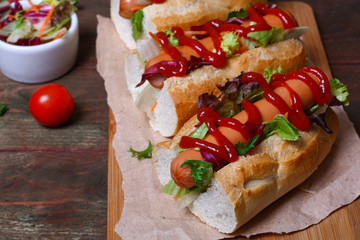 home made Hot dog - sandwich with lettuce on wooden background