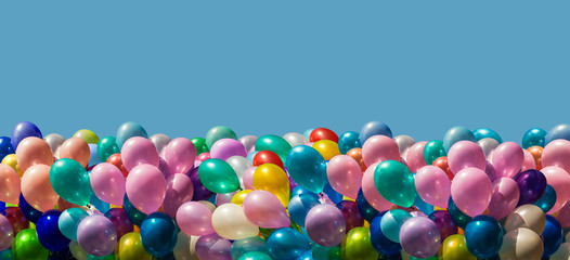Multi-colored balloons isolated on blue © misu