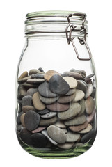Canned pebble. Glass jar with sea pebbles isolated on white bacground.