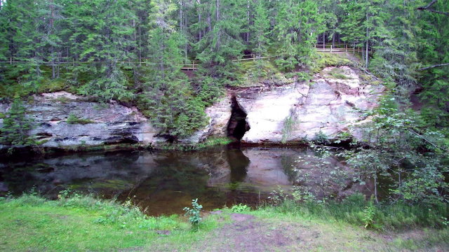 Closer look of the sandstone in the mountain and fronting it is the water from Ahja river in Taevaskoda Estonia