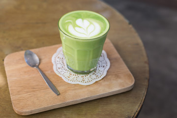 green tea latte on wood background