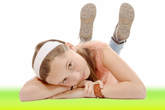 portrait of smiling little girl lying on the floor