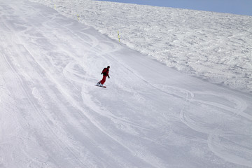 Ski slope and snowboarder at cold day