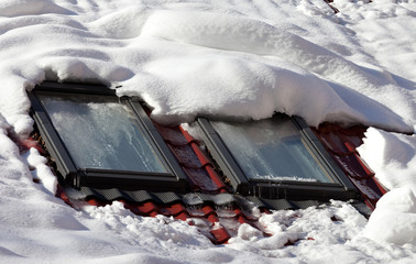 Snowy roof with icy windows