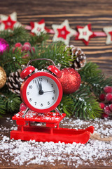 Fototapeta na wymiar Alarm clock with snow and Christmas decorations
