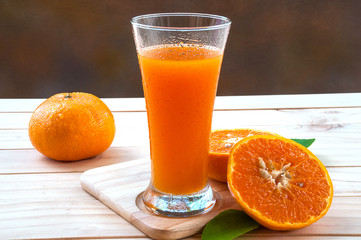 Cold orange juice on wooden table
