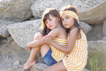 portrait of two girls of girlfriends on a summer nature