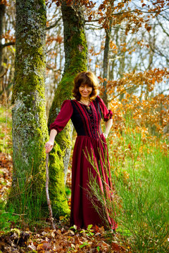 Woman in red dress portrait, autumnal forest