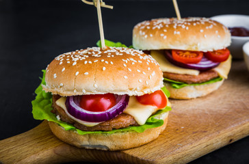 Two hamburgers on kitchen board, studio shot