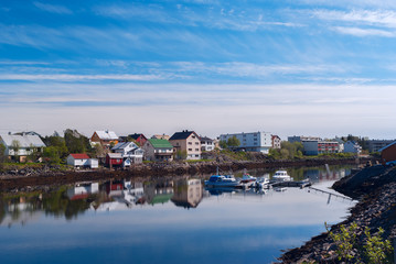 Fototapeta na wymiar Village on the norwegian island with reflection in water