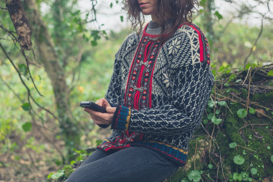 Woman using smartphone in nature