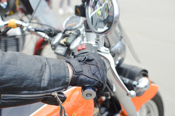 Fototapeta na wymiar Close up picture of hand on motorbike handlebar