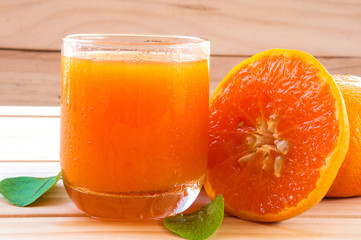Cold orange juice on wooden table