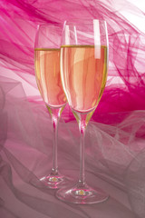 Two Glasses of Champagne with Backlit Tulle Background