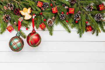 Fototapeta na wymiar Christmas background. Christmas fir tree, gifts, angel, Christmas balls on white wooden background. Copy space