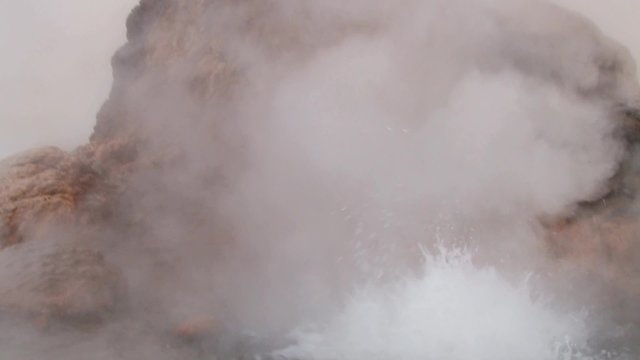 El Tatio geyser boils and produces steam at sunrise at the famous El Tatio geyser valley at 4320 meters above sea level,  Chile.