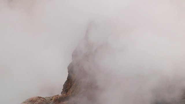 El Tatio geyser boils and produces steam at sunrise at the famous El Tatio geyser valley at 4320 meters above sea level,  Chile.